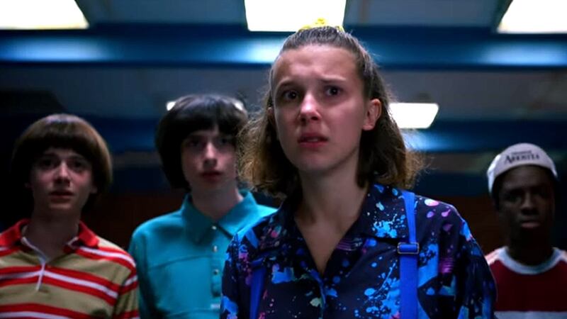 Millie Bobbie Brown, center, is shown in a shot from 'Stranger Things,' which takes place in...
