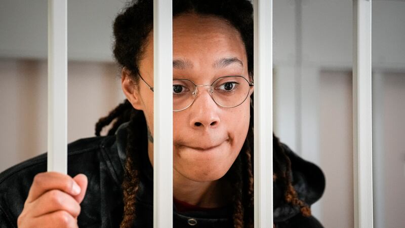 WNBA star and two-time Olympic gold medalist Brittney Griner speaks to her lawyers standing in...