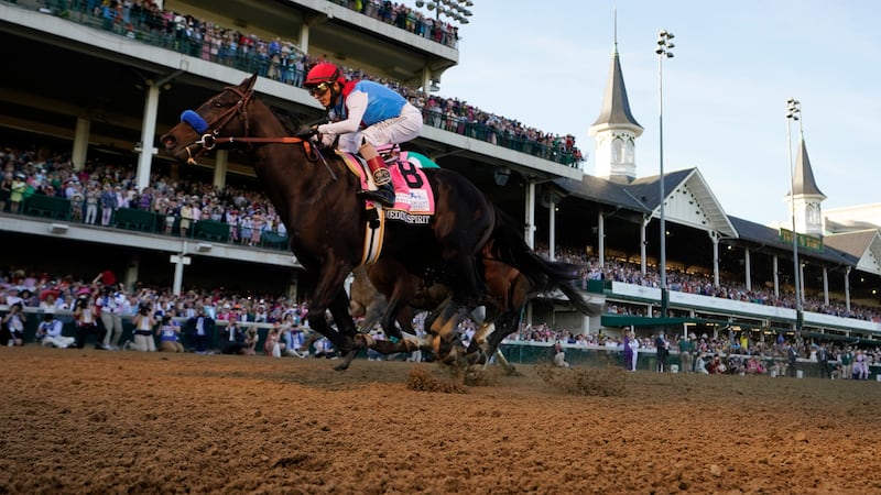 John Velazquez rides Medina Spirit across the finish line to win the 147th running of the...
