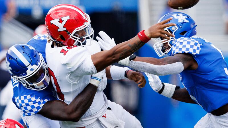 Youngstown State quarterback Demeatric Crenshaw (10) throws the ball away while being tackled...