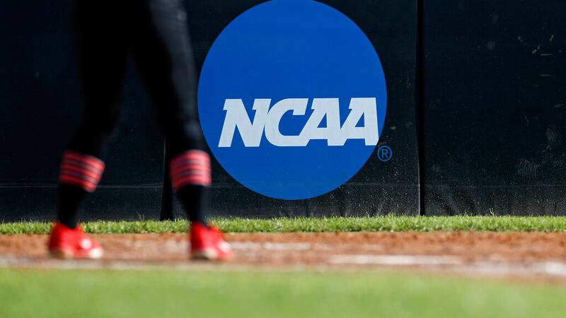 A detail view of the NCAA logo is seen as a Lamar University softball player's cleats are seen...