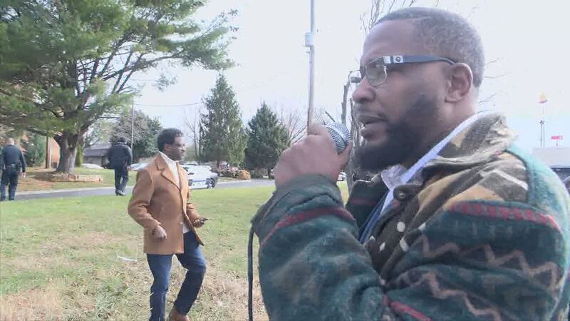 An organizer takes the microphone addressing the police presence in the city surrounding...