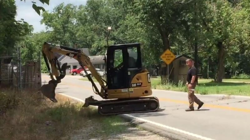 Crews used an excavator to dig holes in hopes of finding Melanie Flynn's remains. (Nick...