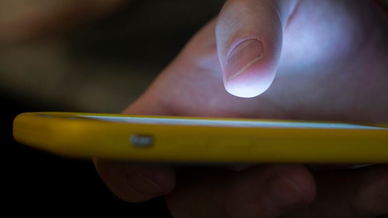 FILE - A man uses a cellphone in New Orleans, Aug. 11, 2019. On Tuesday, May 23, 2023,...
