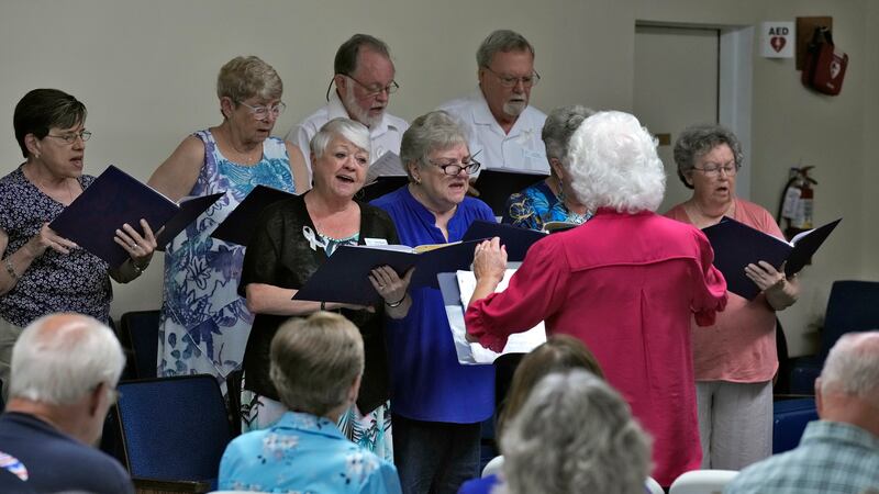 Members of the choir sings along with the congregation during service at the Grace Methodist...