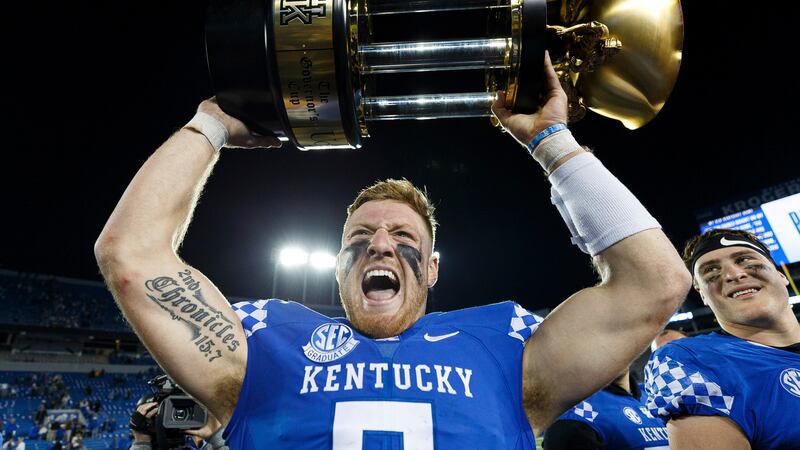 Kentucky quarterback Will Levis holds up the Governor's Cup trophy after Kentucky defeated...