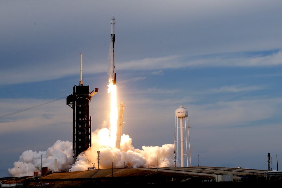A SpaceX Falcon 9 rocket, with the Dragon capsule and a crew of four private astronauts, lifts...