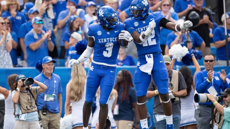 Kentucky defensive back Alex Afari Jr. (3) and linebacker Tyreese Fearbry (42) celebrate after...